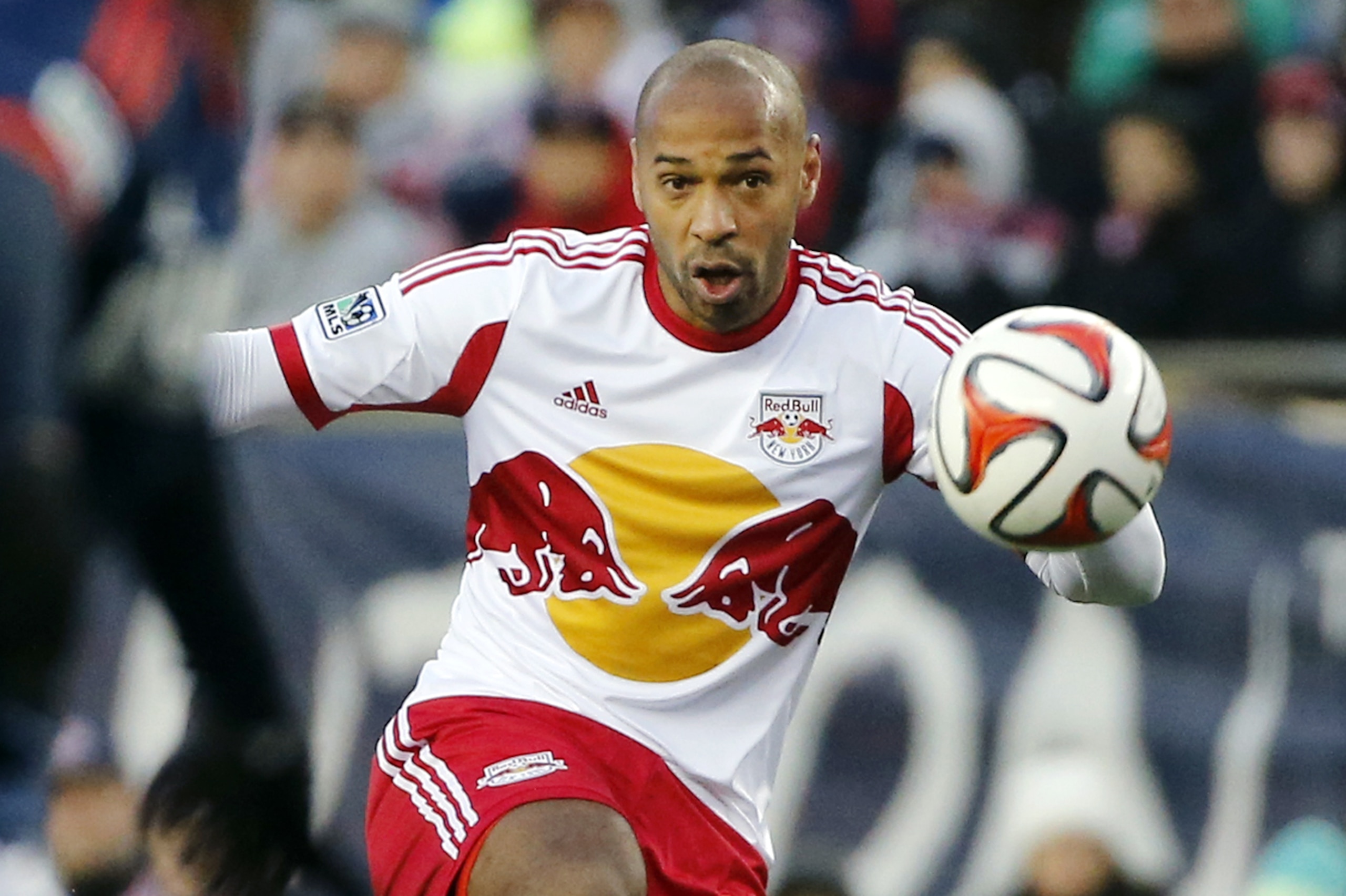 New York Red Bulls forward Thierry Henry handles the ball against the New England Revolution during the first half of the second soccer game of the MLS Eastern Conference final in Foxborough, Mass., Saturday, Nov. 29, 2014. The match ended 2-2 and New England advances with a two-game aggregate 4-3. (AP Photo/Elise Amendola)