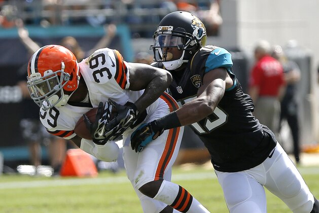 Jacksonville Jaguars wide receiver Allen Robinson (15) tackles Cleveland Browns free safety Tashaun Gipson (39) after he intercepted a pass during the second half of an NFL football game, in Jacksonville, Fla., Sunday, Oct. 19, 2014. Jacksonville beat the Browns 24-6. (AP Photo/Stephen B. Morton)