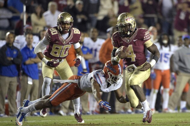 Florida State running back Dalvin Cook (4) rushes for yardage past Florida defensive back Vernon Hargreaves, III (1) during the second half of an NCAA college football game in Tallahassee, Fla., Saturday, Nov. 29, 2014. Florida State won 24-19.(AP Photo/Phelan M. Ebenhack)
