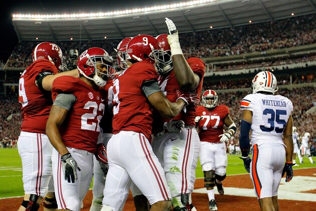 TUSCALOOSA, AL - NOVEMBER 29:  Amari Cooper #9 of the Alabama Crimson Tide celebrates with his teammates after catching a 17 yard touchdown pass from Blake Sims #6 in the first quarter against Jonathan Jones #3 of the Auburn Tigers during the Iron Bowl at Bryant-Denny Stadium on November 29, 2014 in Tuscaloosa, Alabama.  (Photo by Kevin C. Cox/Getty Images)
