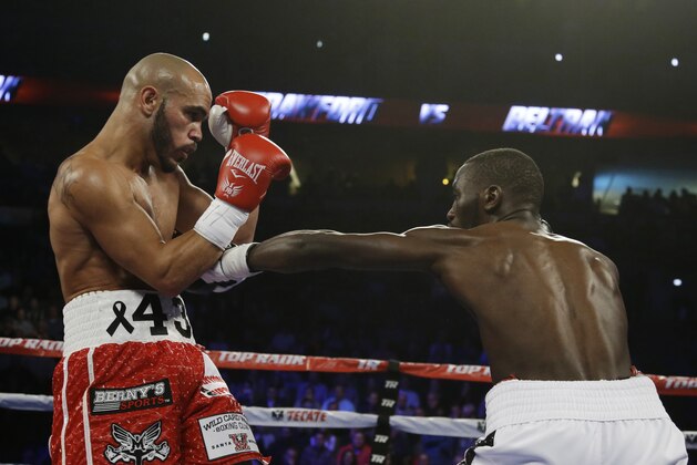 Terence Crawford, right, jabs at  Raymundo Beltran during a WBO lightweight championship boxing bout in Omaha, Neb., in Omaha, Neb., Saturday, Nov. 29, 2014. (AP Photo/Nati Harnik)
