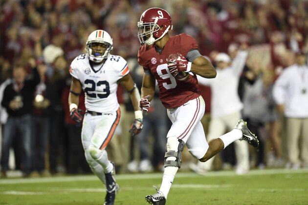 Nov 29, 2014; Tuscaloosa, AL, USA; Alabama Crimson Tide wide receiver Amari Cooper (9) catches a touchdown pass past Auburn Tigers defensive back Johnathan Ford (23) in the third quarter at Bryant-Denny Stadium. Mandatory Credit: John David Mercer-USA TODAY Sports