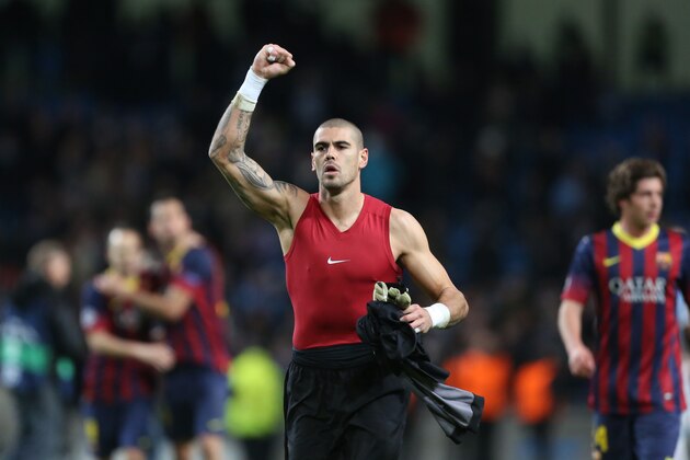 Barcelona goalkeeper Victor Valdes celebrates at the end of the Champions League first knock out round soccer match between Barcelona and Manchester City at the Etihad Stadium, Manchester, England, Tuesday Feb. 18, 2014. (AP Photo/Jon Super)