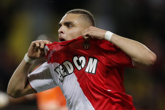 Monaco's Layvin Kurzawa of France reacts  after scoring the third goal during the French League One soccer match against Reims, in Monaco stadium, Friday, Feb. 21 , 2014. (AP Photo/Lionel Cironneau)