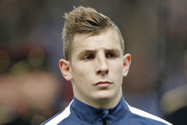 France's Lucas Digne, stands at attention during the Albanian National anthem prior to the start of a friendly soccer match France against Albania at Route de Lorient stadium in Rennes, western France, Friday, Nov. 14, 2014. The match ended in a 1-1 draw. (AP Photo/Michel Euler)