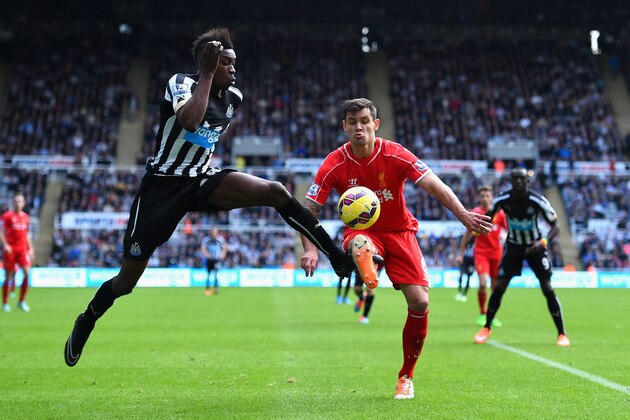NEWCASTLE UPON TYNE, ENGLAND - NOVEMBER 01:  Newcastle player Sammy Ameobi (l) challenges  Dejan Lovren during the Barclays Premier League match between Newcastle United and Liverpool at St James' Park on November 1, 2014 in Newcastle upon Tyne, England.  (Photo by Stu Forster/Getty Images)