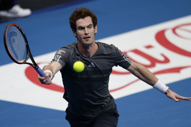 Andy Murray of the Manila Mavericks team returns a shot to Gael Monfils of the Indian Aces during the men's singles of the  International Premier Tennis League at the Mall of Asia Arena at suburban Pasay city, south of Manila, Philippines Saturday, Nov. 29, 2014. Monfils won the match 6-4 which features a new format and a chance for a team championship prize of $1-million dollars. (AP Photo/Bullit Marquez)