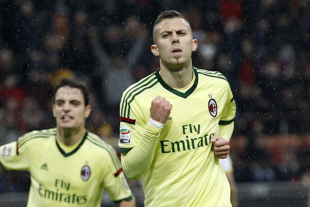 AC Milan's Jeremy Menez, right, celebrates with his  teammate Giacomo Bonaventura after scoring during the Serie A soccer match between AC Milan and Udinese at the San Siro stadium in Milan, Italy, Sunday, Nov. 30, 2014. (AP Photo/Antonio Calanni)