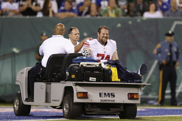 New York Giants guard Geoff Schwartz (74) is carted off the field after an injury in the second quarter against the New York Jets during a preseason NFL football game, Friday, Aug. 22, 2014, in East Rutherford, N.J. (AP Photo/Julio Cortez)