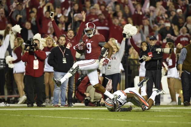 Nov 29, 2014; Tuscaloosa, AL, USA; Alabama Crimson Tide wide receiver Amari Cooper (9) catches a touchdown pass in the third quarter  past Auburn Tigers defensive back Jonathon Mincy (6) at Bryant-Denny Stadium. Mandatory Credit: John David Mercer-USA TODAY Sports