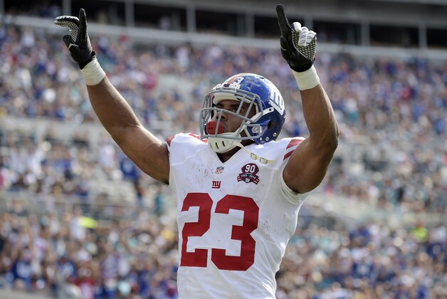 New York Giants running back Rashad Jennings (23) celebrates after a 2-yard touchdown run against the Jacksonville Jaguars during the first half of an NFL football game in Jacksonville, Fla., Sunday, Nov. 30, 2014. (AP Photo/Phelan M. Ebenhack)