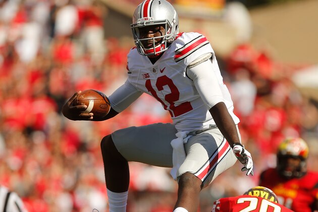 COLLEGE PARK, MD - OCTOBER 04:  Quarterback Cardale Jones #12 of the Ohio State Buckeyes hurdles safety Anthony Nixon #20 of the Maryland Terrapins during the fourth quarter of Ohio State's 52-24 win at Byrd Stadium on October 4, 2014 in College Park, Maryland.  (Photo by Jonathan Ernst/Getty Images)
