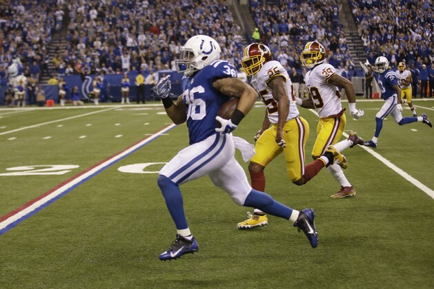 Indianapolis Colts running back Dan Herron runs against the Washington Redskins during the first half of an NFL football game Sunday, Nov. 30, 2014, in Indianapolis. (AP Photo/Darron Cummings)
