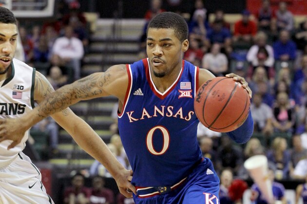 Kansas guard Frank Mason III (0) drives down court against Michigan State guard Bryn Forbes (5) during the first half of an NCAA college basketball game in Lake Buena Vista, Fla., Sunday, Nov. 30, 2014. (AP Photo/Reinhold Matay)