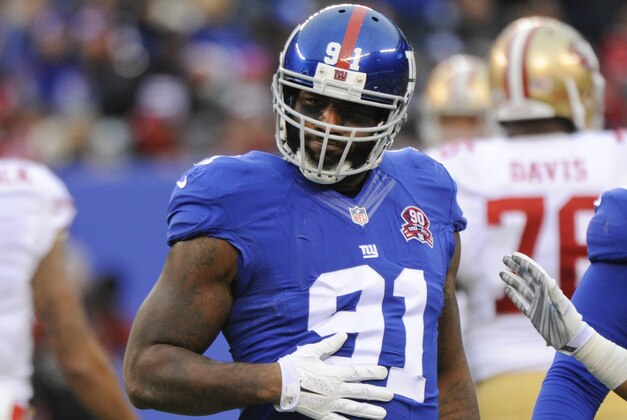 New York Giants defensive end Robert Ayers (91) celebrates after sacking San Francisco 49ers quarterback Colin Kaepernick (7) during the first half of an NFL football game Sunday, Nov. 16, 2014, in East Rutherford, N.J.  (AP Photo/Bill Kostroun)