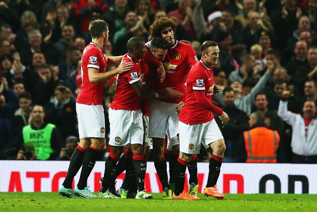MANCHESTER, ENGLAND - NOVEMBER 29:  Robin van Persie of Manchester United (C) celebrates scoring their third goal with team mates during the Barclays Premier League match between Manchester United and Hull City at Old Trafford on November 29, 2014 in Manchester, England.  (Photo by Matthew Lewis/Getty Images)