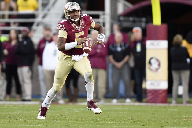Nov 29, 2014; Tallahassee, FL, USA; Florida State Seminoles quarterback Jameis Winston (5) looks to throw as he scrambles during the second quarter against the Florida Gators at Doak Campbell Stadium. Mandatory Credit: Tommy Gilligan-USA TODAY Sports