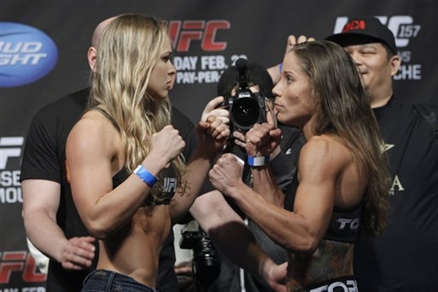 Mixed martial arts fighter UFC bantamweight champion, Ronda Rousey, left, and opponent Liz Carmouche face off at the Honda Center in Anaheim, Calif., Friday, Feb. 22, 2013. Champion Rousey will fight Liz Carmouche in the main event at UFC 157 at the Honda Center on Saturday Feb. 23, in the first women's bout in the UFC promotion's history.(AP Photo/Damian Dovarganes)
