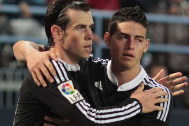 MALAGA, SPAIN - NOVEMBER 29:  Gareth Bale of Real Madrid (L) celebrates his goal with team mate James Rodriguez after scoring during the La Liga match between Malaga CF and Real Madrid CF at La Rosaleda studium on November 29, 2014 in Malaga, Spain. (Photo by Sergio Camacho/Getty Images)
