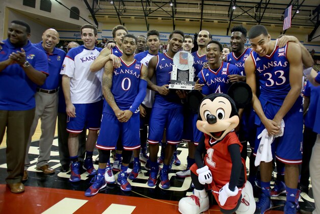 Kansas displays the Orlando Classic championship trophy following an NCAA college basketball game against Michigan State in Lake Buena Vista, Fla., Sunday, Nov. 30, 2014. Kansas won 61-56. (AP Photo/Reinhold Matay)