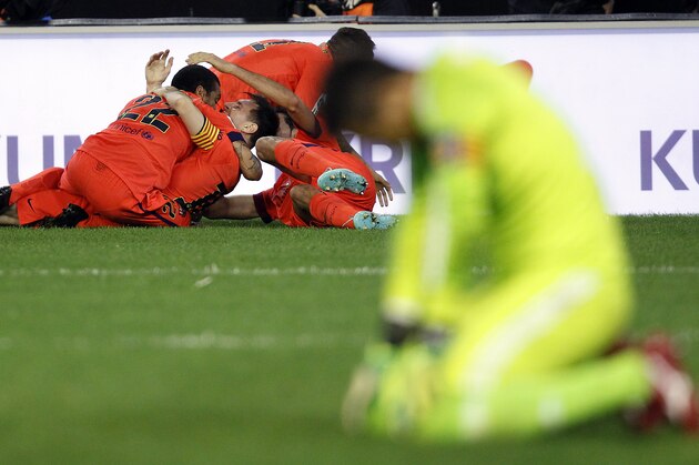 Barcelona's Sergio Busquets, rear right, celebrates after scoring against Valencia during a Spanish La Liga soccer match at the Mestalla stadium in Valencia, Spain, on Sunday, Nov. 30, 2014.(AP Photo/Alberto Saiz)