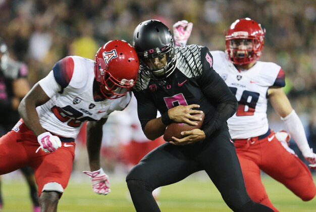 Oct 2, 2014; Eugene, OR, USA; Oregon Ducks quarterback Marcus Mariota (8) makes a catch thrown by Oregon Ducks running back Royce Freeman (21) for a touchdown in the second quarter against the Arizona Wildcats at Autzen Stadium. Mandatory Credit: Scott Olmos-USA TODAY Sports