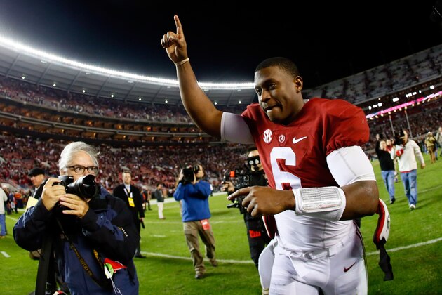 TUSCALOOSA, AL - NOVEMBER 29:  Blake Sims #6 of the Alabama Crimson Tide celebrates as he runs off the field after defeating the Auburn Tigers in the Iron Bowl at Bryant-Denny Stadium on November 29, 2014 in Tuscaloosa, Alabama. The Alabama Crimson Tide defeated the Auburn Tigers 55 to 44.  (Photo by Kevin C. Cox/Getty Images)