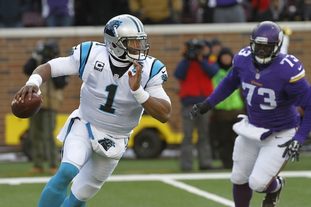 Carolina Panthers quarterback Cam Newton, left, scrambles during the first half of an NFL football game against the Minnesota Vikings, Sunday, Nov. 30, 2014, in Minneapolis. (AP Photo/Ann Heisenfelt)