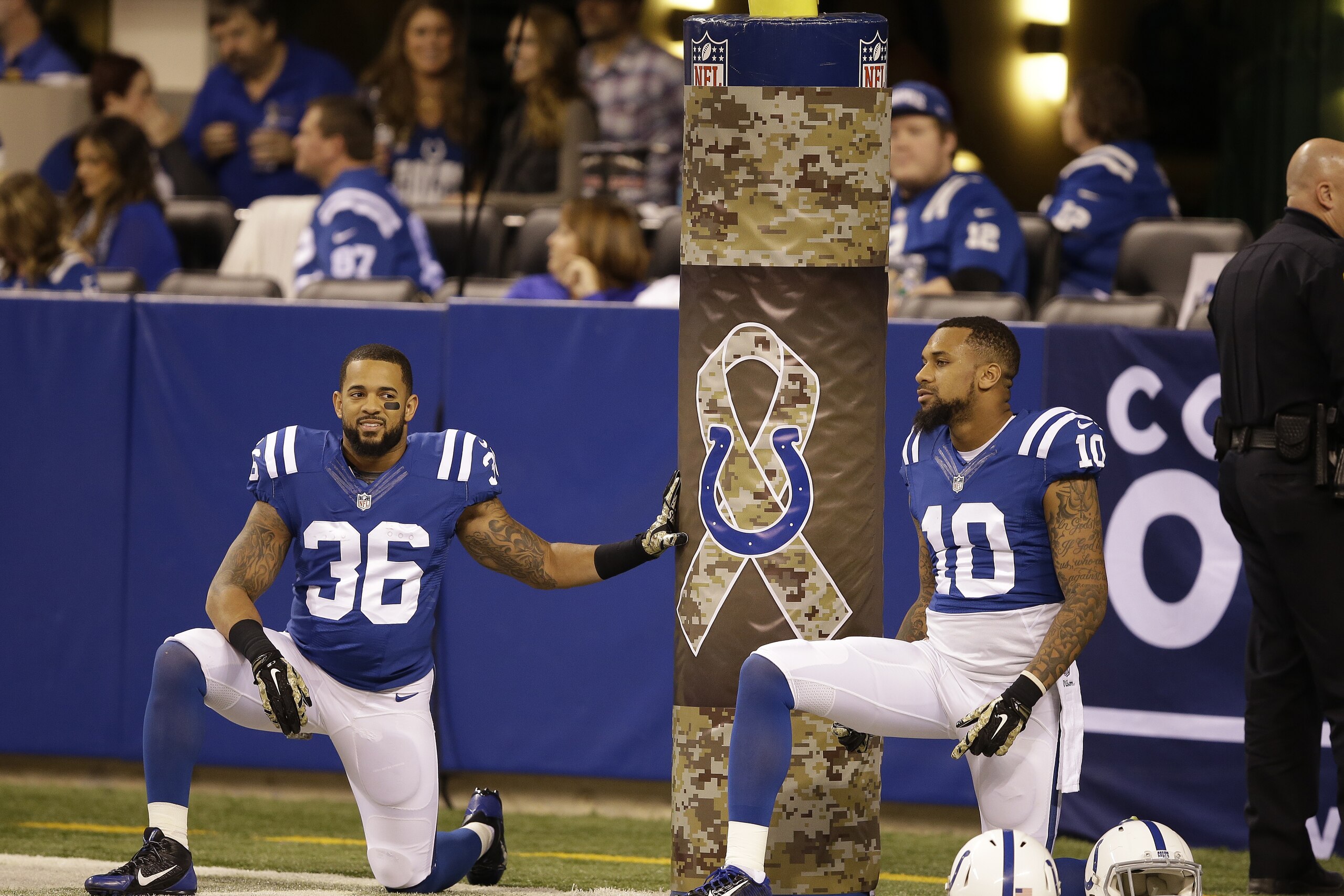 Indianapolis Colts running back Dan Herron, left, and Indianapolis Colts wide receiver Donte Moncrief warm up before an NFL football game against the New England Patriots, in Indianapolis, Sunday, Nov. 16, 2014. (AP Photo/Darron Cummings)