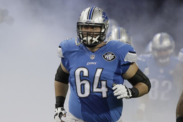 Detroit Lions center Travis Swanson (64) runs on to the field before an NFL football game against the New Orleans Saints in Detroit, Sunday, Oct. 19, 2014. (AP Photo/Duane Burleson)