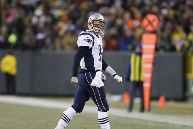 New England Patriots' Tom Brady looks back as he walks off the field during the second half of an NFL football game against the Green Bay Packers Sunday, Nov. 30, 2014, in Green Bay, Wis. The Packers won 26-21. (AP Photo/Tom Lynn)