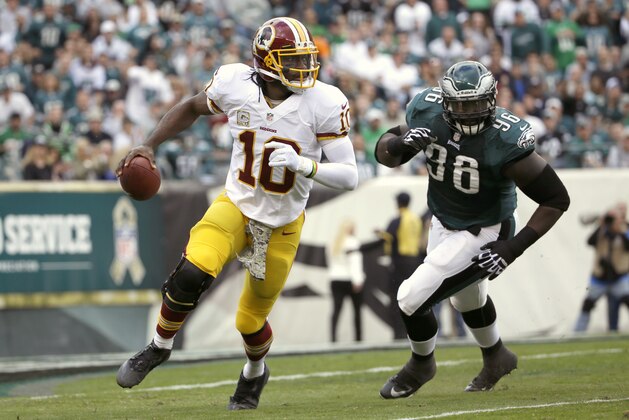 Washington Redskins quarterback Robert Griffin III, left, scrambles past Philadelphia Eagles nose tackle Bennie Logan during the first half of an NFL football game in Philadelphia, Sunday, Nov. 17, 2013. (AP Photo/Matt Slocum) Washington Redskins quarterback Robert Griffin III, left, scrambles past Philadelphia Eagles nose tackle Bennie Logan during the first half of an NFL football game in Philadelphia, Sunday, Nov. 17, 2013. (AP Photo/Matt Slocum)