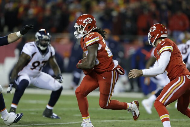 Kansas City Chiefs running back Jamaal Charles (25) runs with the ball as Denver Broncos defensive end Malik Jackson (97) looks on, in the first half of an NFL football game in Kansas City, Mo., Sunday, Nov. 30, 2014. (AP Photo/Ed Zurga)