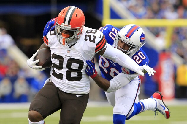 Cleveland Browns running back Terrance West (28) breaks away from a tackle by Buffalo Bills cornerback Corey Graham (20) during the first half of an NFL football game, Sunday, Nov. 30, 2014, in Orchard Park, N.J. (AP Photo/Bill Wippert)