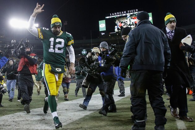 GREEN BAY, WI - NOVEMBER 30:  Quarterback Aaron Rodgers #12 of the Green Bay Packers runs off the field following the NFL game against the New England Patriots at Lambeau Field on November 30, 2014 in Green Bay, Wisconsin. The Green Bay Packers defeated the New England Patriots 26-21.  (Photo by Mike McGinnis/Getty Images)