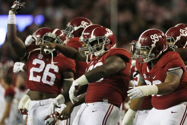 Alabama players celebrate in the closing seconds of the second half of the Iron Bowl NCAA college football game, Saturday, Nov. 29, 2014, in Tuscaloosa, Ala. Alabama won 55-44. (AP Photo/Brynn Anderson)