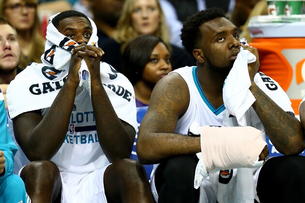 CHARLOTTE, NC - NOVEMBER 26:  (L-R) Teammates Lance Stephenson #1 and P.J. Hairston #19 of the Charlotte Hornets watch on from the bench during their game against the Portland Trail Blazers at Time Warner Cable Arena on November 26, 2014 in Charlotte, North Carolina.  NOTE TO USER: User expressly acknowledges and agrees that, by downloading and or using this photograph, User is consenting to the terms and conditions of the Getty Images License Agreement.  (Photo by Streeter Lecka/Getty Images)