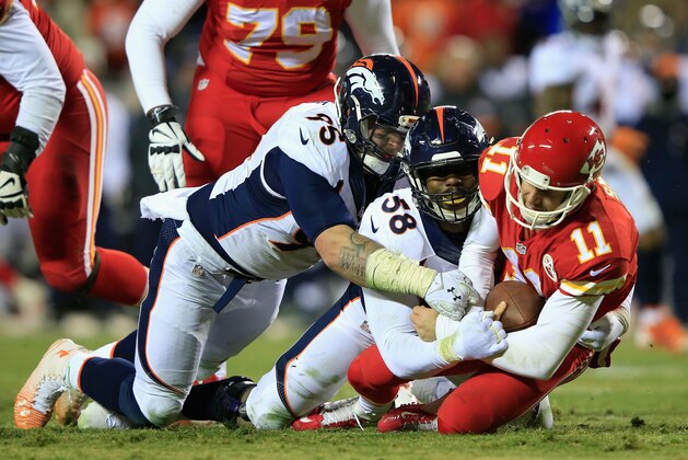 KANSAS CITY, MO - NOVEMBER 30: Alex Smith #11 of the Kansas City Chiefs is sacked by  Derek Wolfe #95 and Von Miller #58 of the Denver Broncos during the fourth quarter at Arrowhead Stadium on November 30, 2014 in Kansas City, Missouri.  (Photo by Jamie Squire/Getty Images)