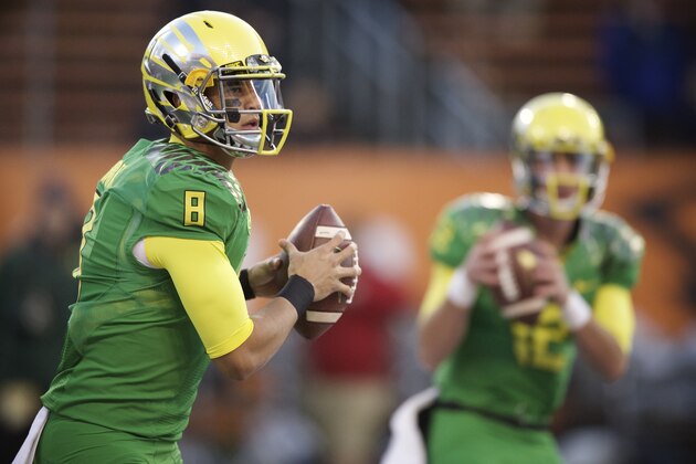 Oregon quarterback Marcus Mariota (8) warms up before an NCAA college football game against Oregon State in Corvallis, Or., Saturday, Nov. 15, 2014. (AP Photo/Troy Wayrynen)