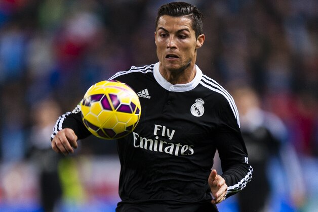 Real Madrid's Cristiano Ronaldo from Portugal in action during a Spanish La Liga soccer match between Malaga and Real Madrid at La Rosaleda stadium in Malaga, Spain, Saturday Nov. 29, 2014. (AP Photo/Daniel Tejedor)