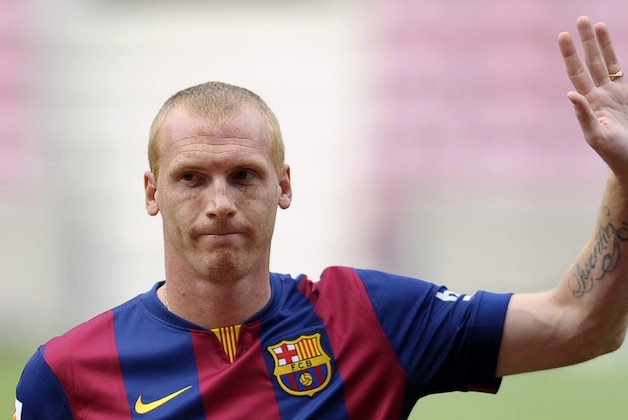 FC Barcelona's new French player Jeremy Mathieu waves during his official presentation at the Camp Nou stadium in Barcelona, Spain, Thursday, July 24, 2014.  Barcelona says it has signed France defender Jeremy Mathieu on a four-year contract with an option to extend it for another season. Barcelona says it has paid 20 million euros ($27 million) for the 30-year-old Mathieu, with a buyout clause fixed at 50 million euros. (AP Photo/Manu Fernandez)