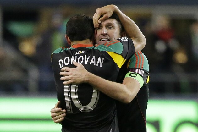 Los Angeles Galaxy captain Robbie Keane, right, hugs Landon Donovan (10) after the Galaxy won the MLS western conference championship, Sunday, Nov. 30, 2014, in Seattle. Sunday's soccer match ended with a score of 2-1 in favor of the Sounders, but the Galaxy won the championship with a 2-2 two-match aggregate score and the advantage of an away goal, and will face the New England Revolution in the MLS Cup on Dec. 7, 2014. (AP Photo/Ted S. Warren)