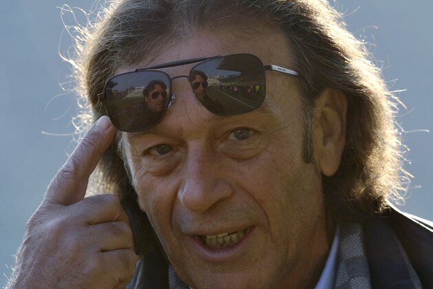 FILE - A Sunday, Dec. 15, 2013 photo from files of the then Cagliari president Massimo Cellino gesturing prior to the Serie A soccer match between Parma and Cagliari at Parma's Tardini stadium. Massimo Cellino _ with his sunglasses and slick, graying hair _ breezed into Elland Road in April when his company, which already owned Italian side Cagliari, bought a controlling stake in Leeds. This was the biggest football team in England in the late 1960s and early ‘70s in the era of Johnny Giles and Billy Bremner, the league champion in 1992 when Eric Cantona starred up front and a Champions League semifinalist only 12 years ago. (AP Photo/Marco Vasini, File)