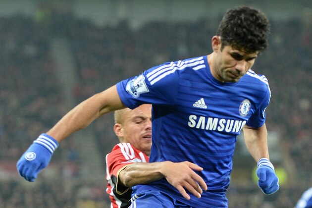 SUNDERLAND, ENGLAND - NOVEMBER 29: Wes Brown of Sunderland tackles Diego Costa of Chelsea during the Barclays Premier League match between Sunderland and Chelsea at the Stadium of Light on November 29, 2014 in Sunderland, England.  (Photo by Tony Marshall/Getty Images)