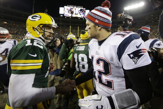 Green Bay Packers' Aaron Rodgers shakes hands with New England Patriots' Tom Brady after an NFL football game Sunday, Nov. 30, 2014, in Green Bay, Wis. The Packers won 26-21. (AP Photo/Tom Lynn)