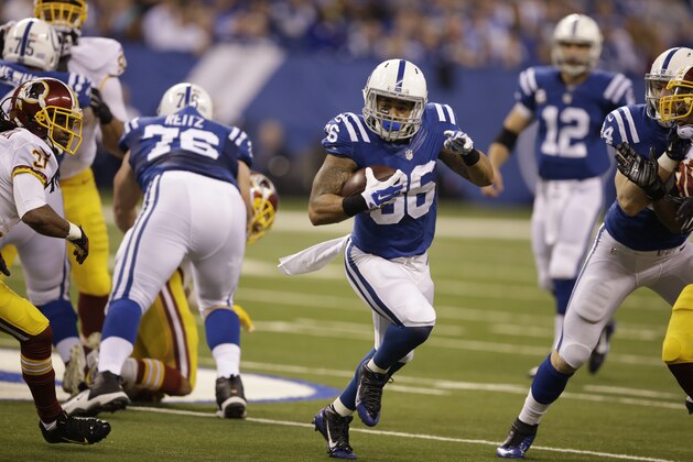 Indianapolis Colts running back Dan Herron runs against the Washington Redskins during the first half of an NFL football game Sunday, Nov. 30, 2014, in Indianapolis. (AP Photo/Darron Cummings)