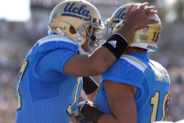 PASADENA, CA - NOVEMBER 28:  Brett Hundley #17 of the UCLA Bruins celebrates his touchdown pass to Thomas Duarte #18 to take a 7-0 lead over the Stanford Cardinal at Rose Bowl on November 28, 2014 in Pasadena, California.  (Photo by Harry How/Getty Images)