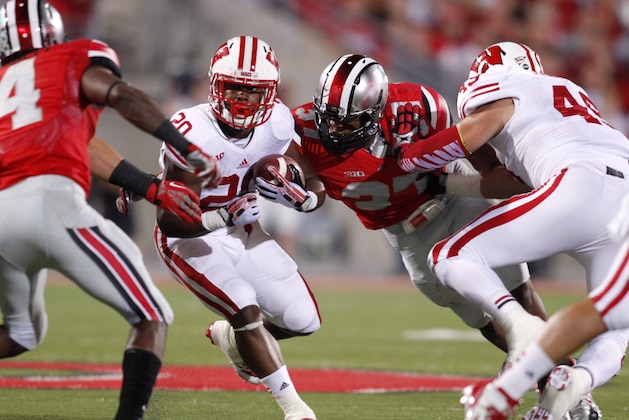 Wisconsin running back James White (20) tries to get past Ohio State linebacker Joshua Perry (37) during an NCAA college football game Saturday, Sept. 28, 2013, in Columbus, Ohio. Ohio State beat Wisconsin 31-24. (AP Photo/Paul Vernon) Wisconsin running back James White (20) tries to get past Ohio State linebacker Joshua Perry (37) during an NCAA college football game Saturday, Sept. 28, 2013, in Columbus, Ohio. Ohio State beat Wisconsin 31-24. (AP Photo/Paul Vernon)