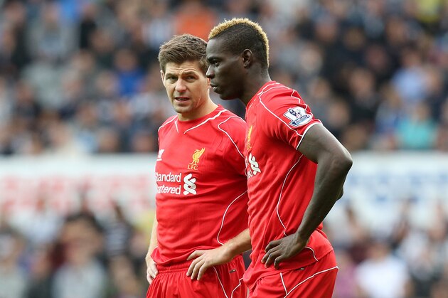 Liverpool's captain Steven Gerrard, left, and Mario Balotelli, right, during their English Premier League soccer match against Newcastle United at St James' Park, Newcastle, England, Saturday, Nov. 1, 2014. (AP Photo/Scott Heppell)