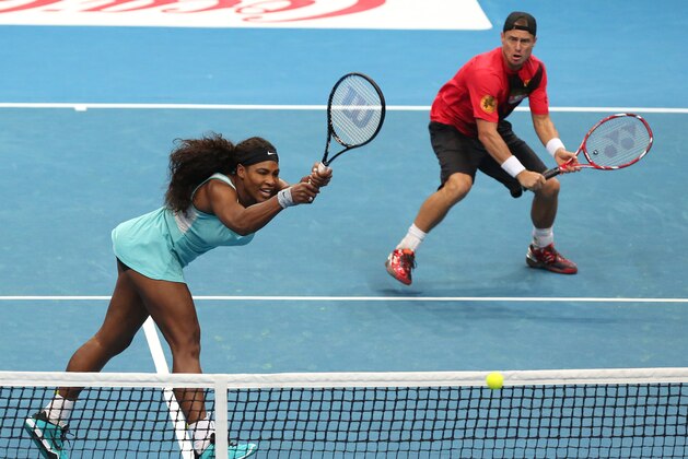 Singapore Slammers Serena Williams, left, in action with Lleyton Hewitt against Manila Mavericks Kirsten Flipkens and Andy Murray during their Mixed Doubles match at the IPTL (International Premier Tennis League) on Sunday, Nov. 30, 2014 at the Mall of Asia Arena in suburban Pasay city, south of Manila, Philippines. The IPTL, featuring four teams, introduces a new format in tennis and a chance for a championship prize of $1-million dollars. Manila Maverick won the match. (AP Photo/Aaron Favila)
